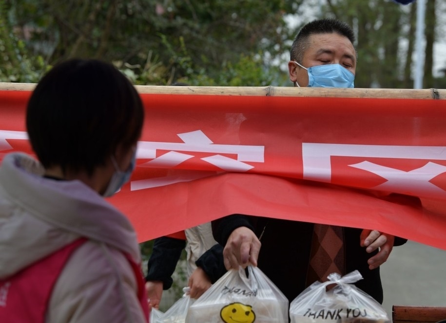 直击中风险区永安村8组：志愿者隔门送盒饭 隔离村民可以分时下地摘菜